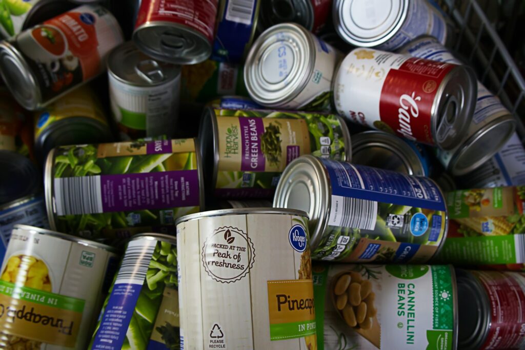 Voorraadkast met blikken groente, potten bonen en pakken crackers